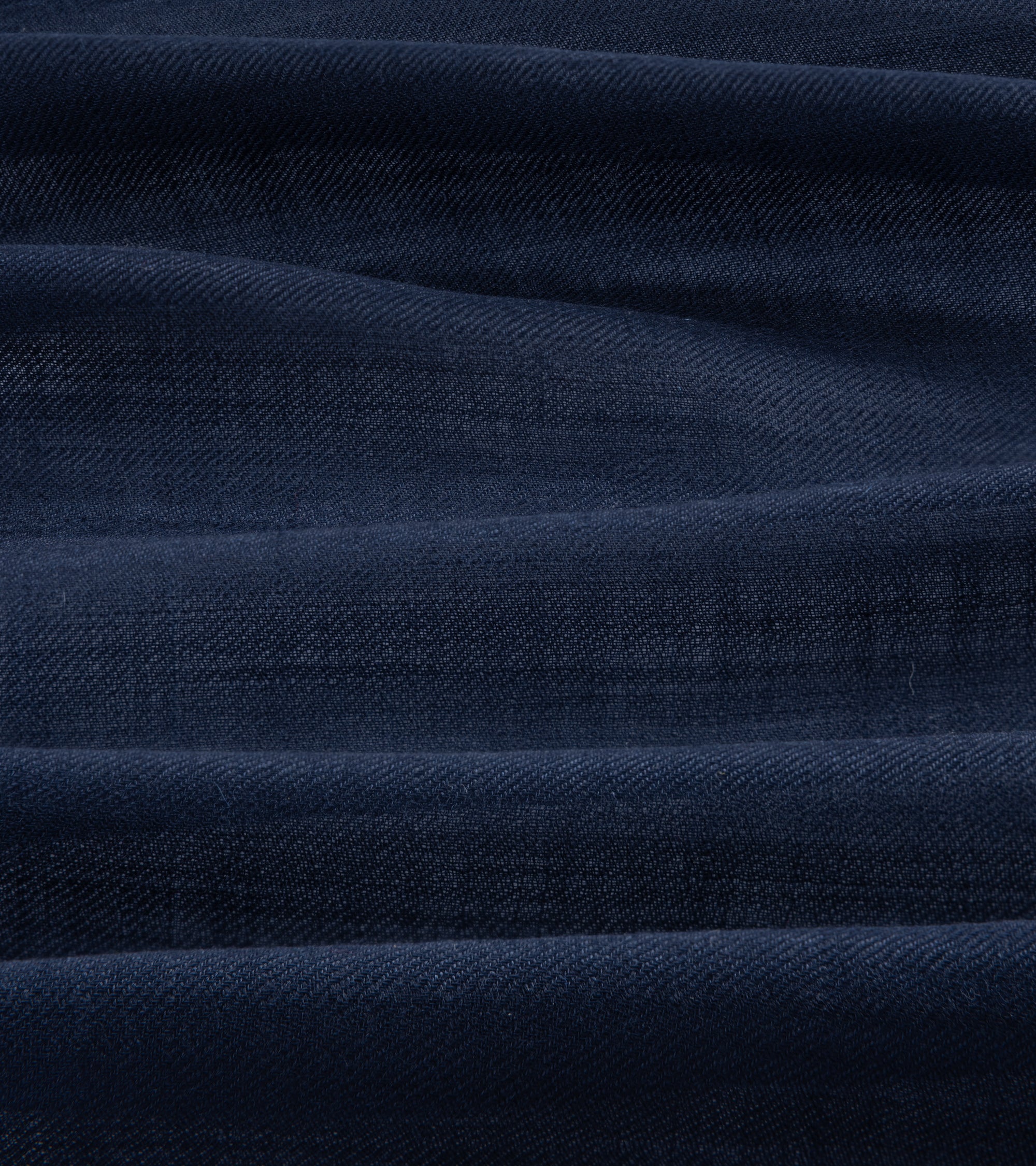 A close-up of dark navy blue textured fabric.