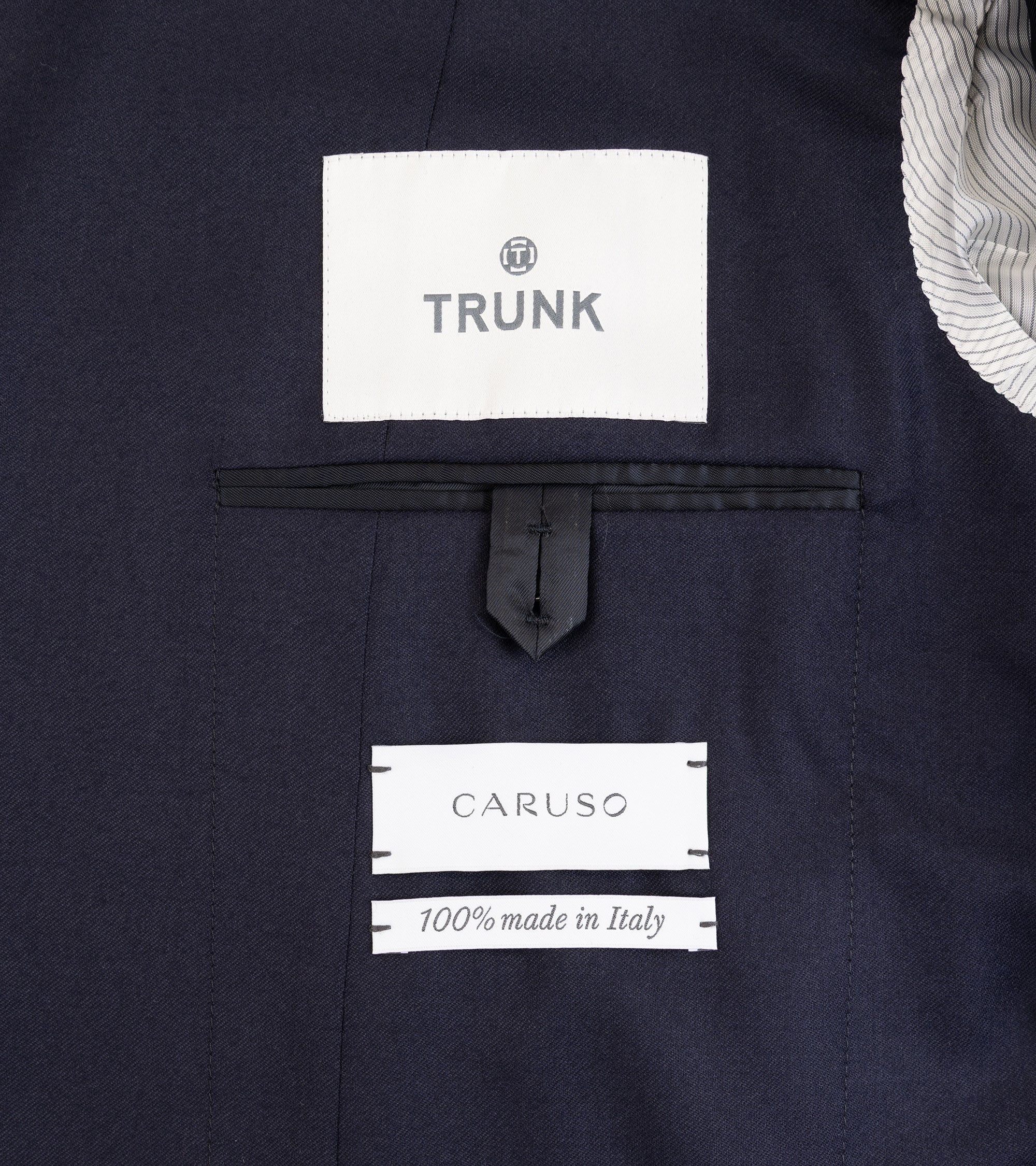 Caruso superlight wool flannel suit in navy, close-up detail of the inner pocket and labels.