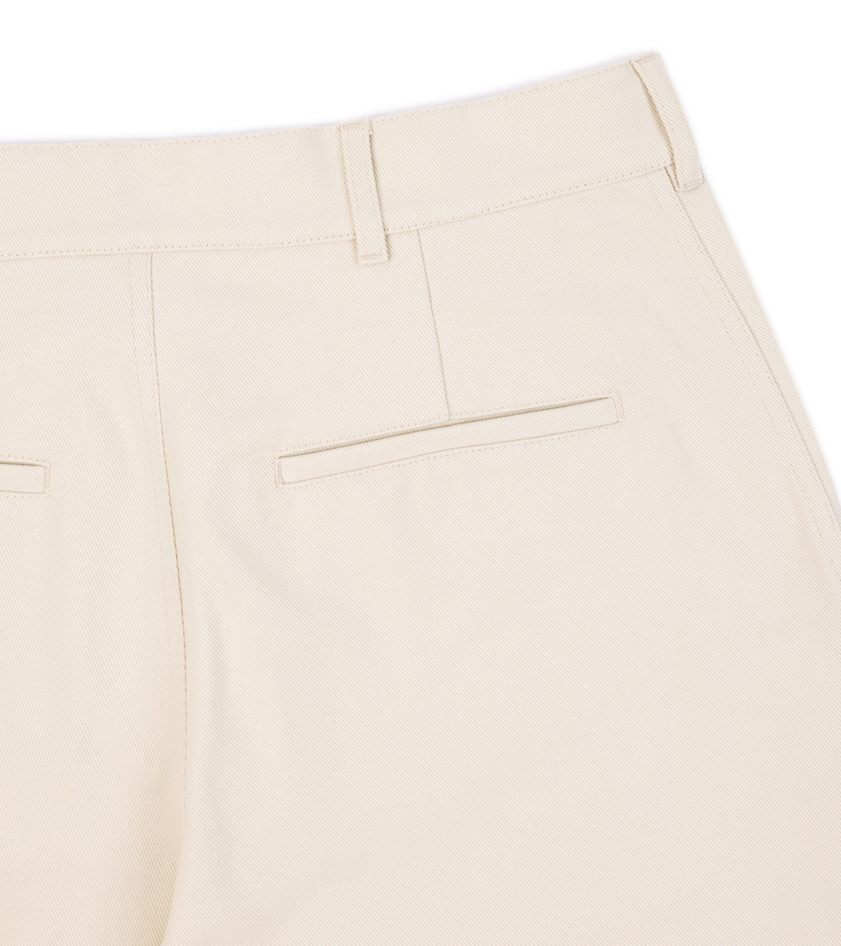 Close-up of the De Bonne Facture Heavy Cotton Balloon Trousers in Cream showing the back waistband, belt loops and a welt pocket.