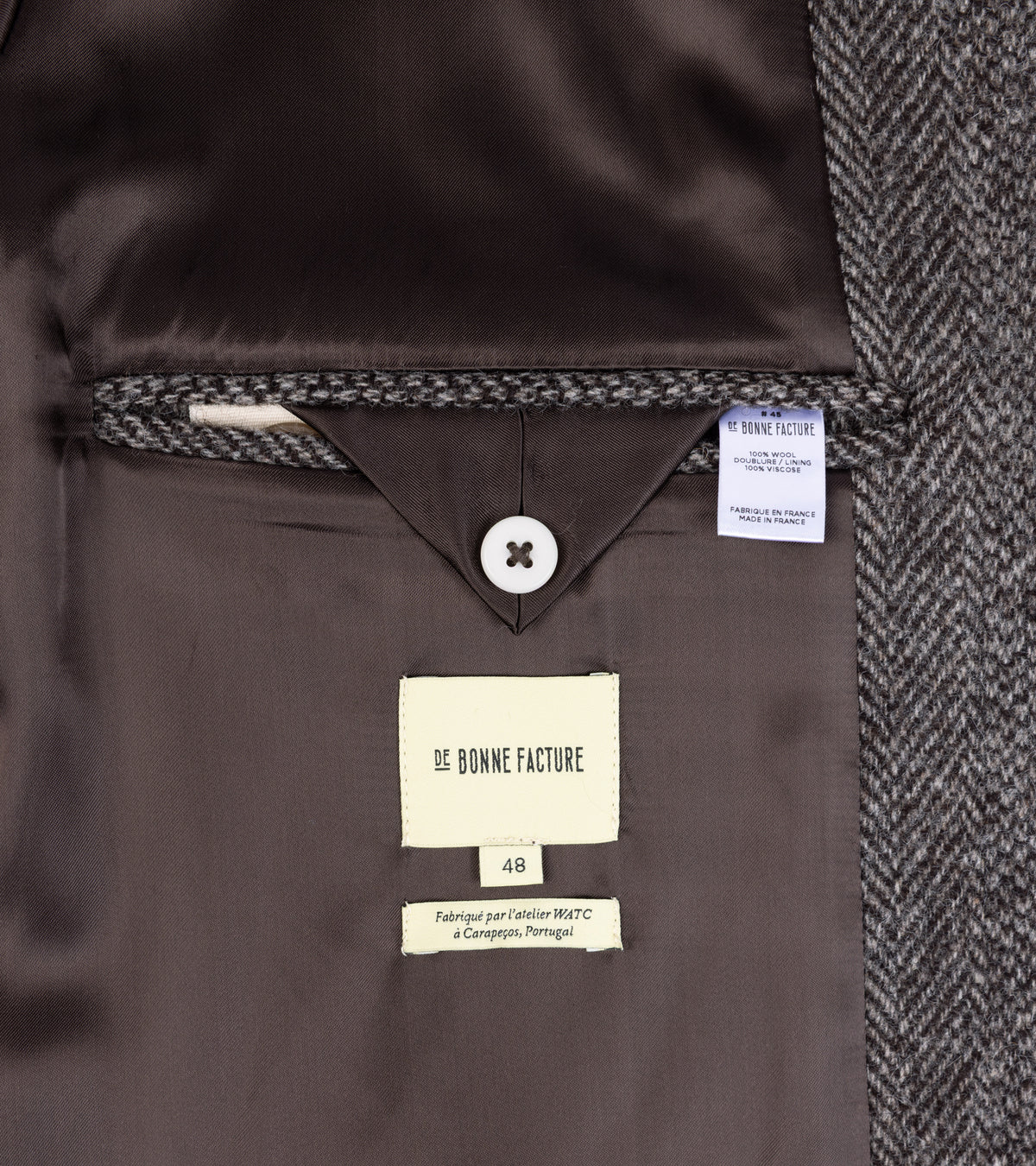 De Bonne Facture Herringbone Wool Overcoat in Undyed Brown, showing the inside pocket and fabric details.
