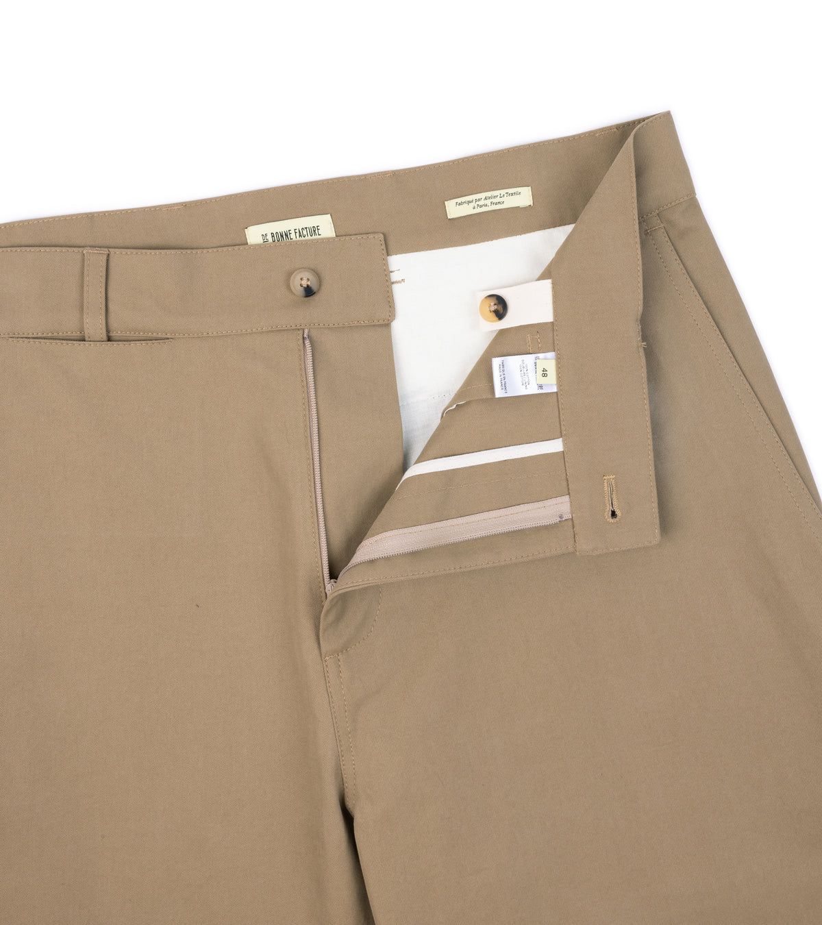 Close-up of the De Bonne Facture Soft Cotton Balloon Trousers in Bronze, showing the waistband and button closure.