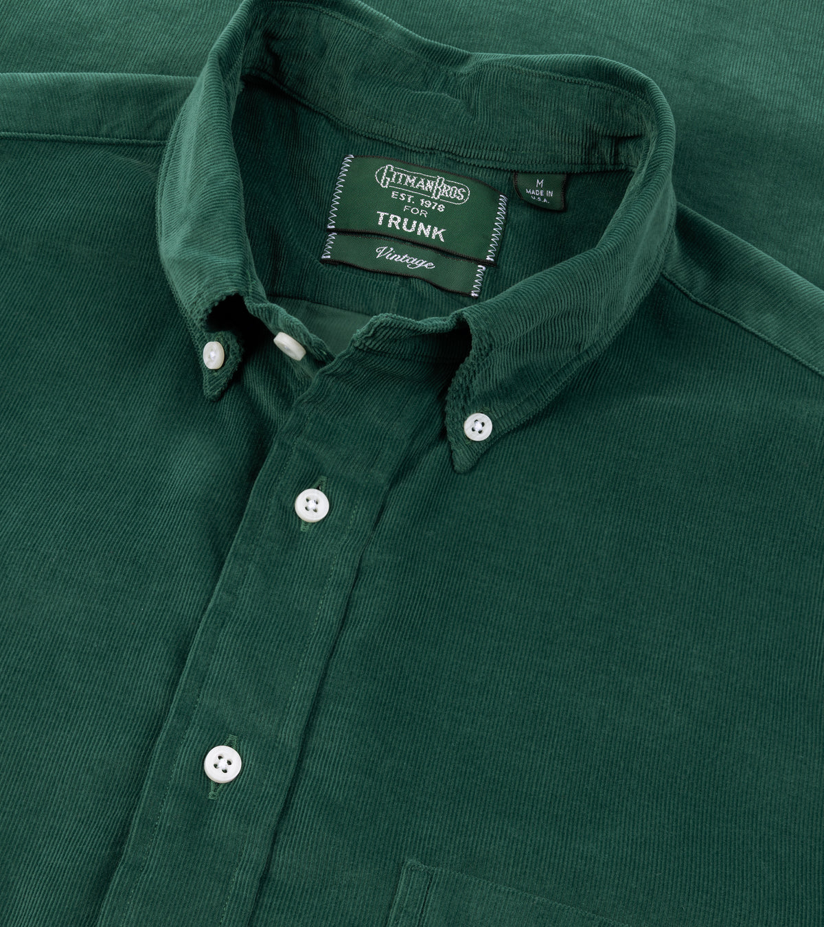 A close-up of the Gitman Vintage Fine Cord Button Down Shirt in Green showing the collar, front buttons, and fabric texture.