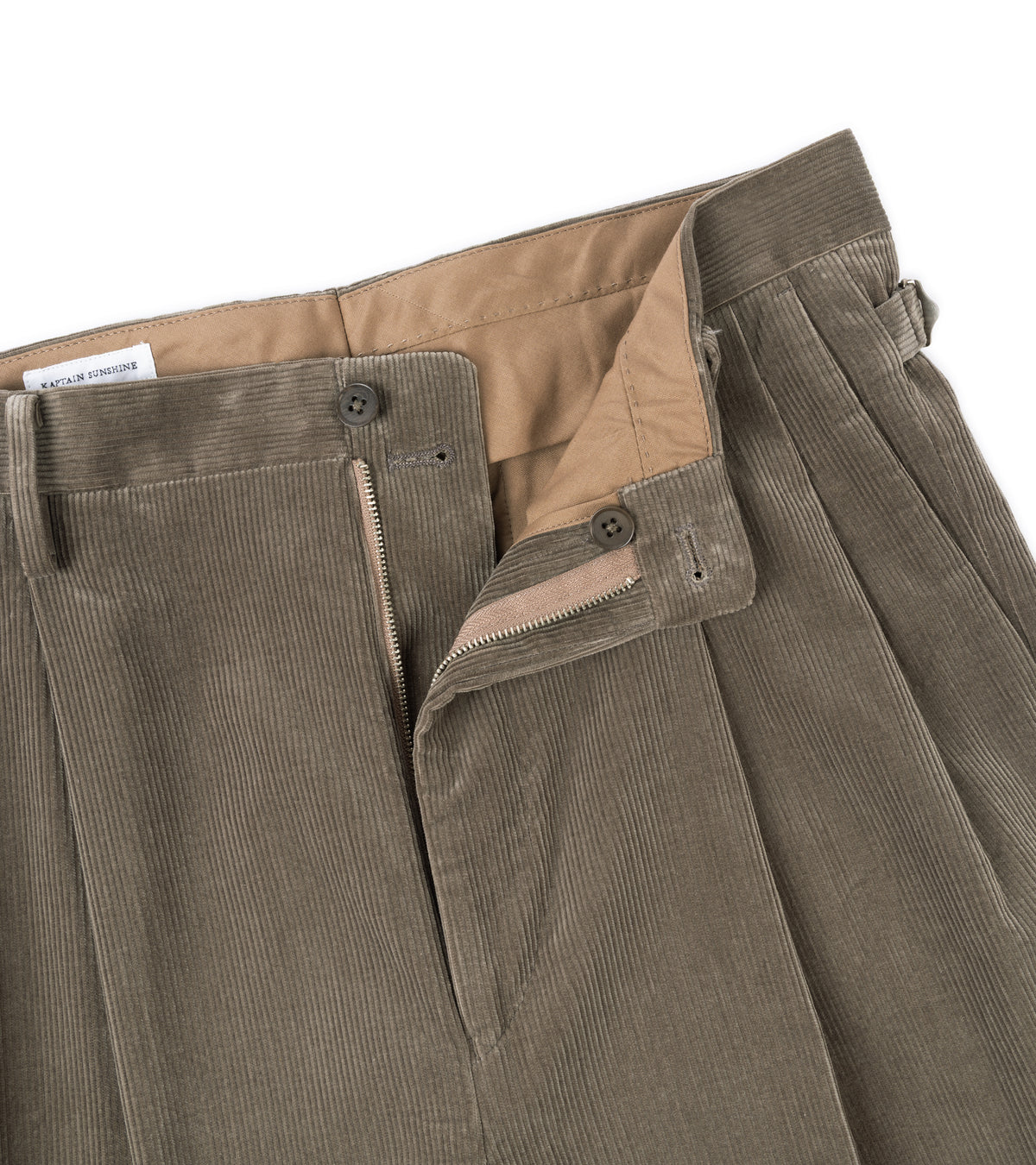 Close-up of the Kaptain Sunshine Cotton Corduroy Shoecut Slacks in Brown showing the front zip fly, button closure, and tan inner lining.