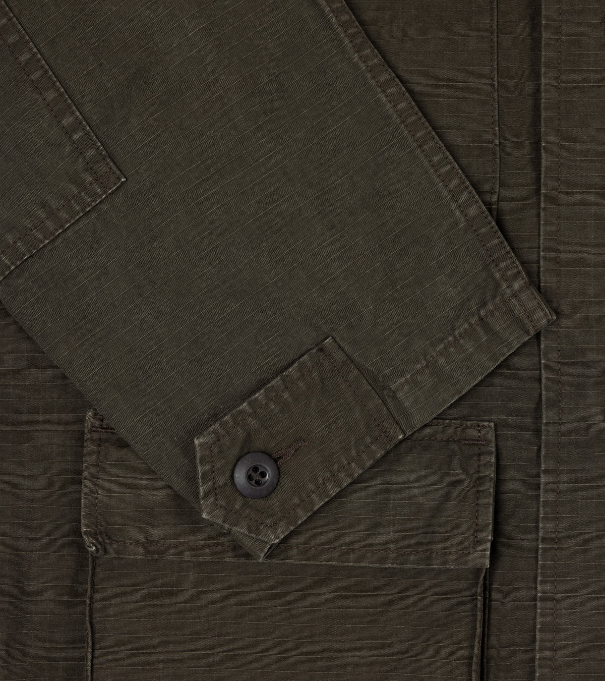 OrSlow Ripstop Cotton BDU Jacket, close-up detail of the ripstop fabric, sleeve with adjustable button cuffs and pocket.