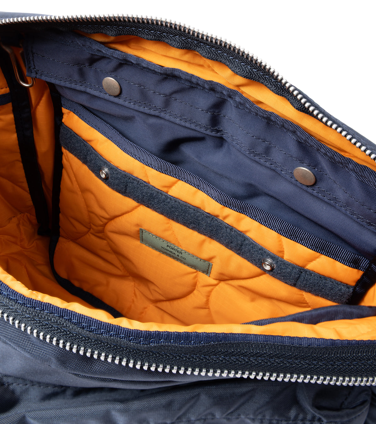 PORTER Force Shoulder Bag in Navy. Shot of inside the bag. Detail of the orange quilted lining and inside pocket.