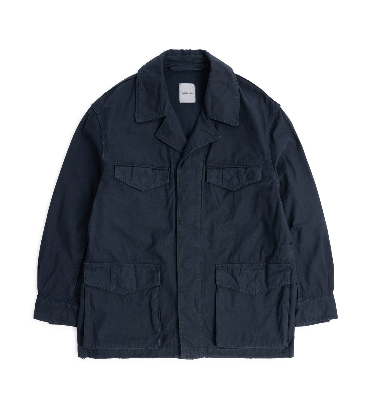 Sage de Cret Cotton Linen Back Satin M-47 Style Jacket in Navy, front view. The jacket features a concealed button front, four utility pockets: two on the chest with flap and hidden snap closure, two lower hand pockets with flap and hidden snap closure.