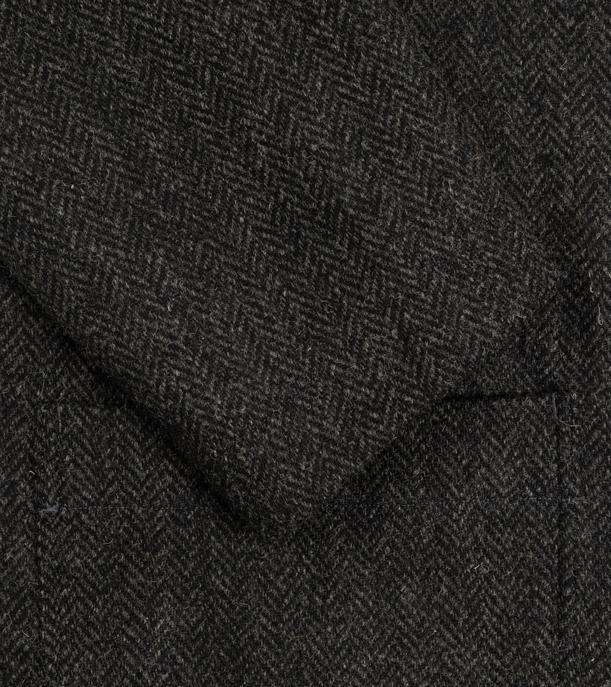 Sage de Cret Harris Tweed Four-Button Coverall Jacket in grey, close-up detail of the fabric, sleeve and pocket.