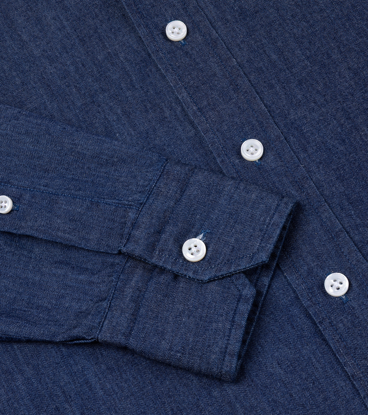 Salvatore Piccolo Cotton Chambray Shirt in Navy. Close-up detail of the buttoned cuff on the sleeve and front placket.