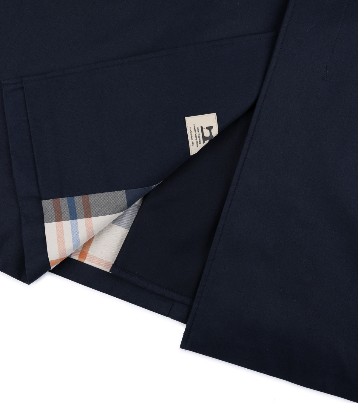Close-up detail of the back hem of the Sanyo 100 Year Lightweight Gabardine Balmacaan Coat in Navy.