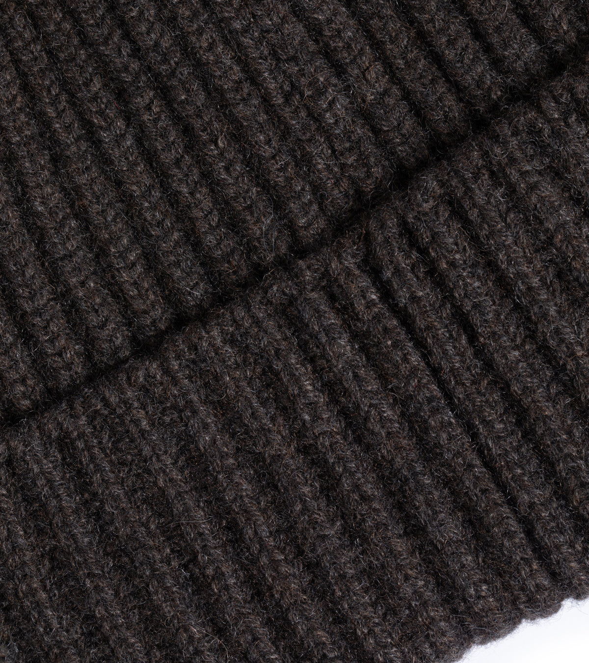 Close-up of the Trunk Seamless Ribbed Cashmere Beanie in Dark Chocolate showing the fabric texture and detailed weave.