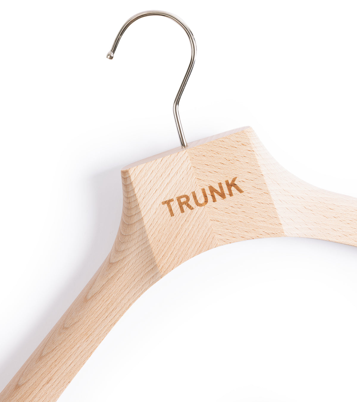 Close-up of Trunk Wooden Suit Hanger with a metal hook and the 'TRUNK' logo engraved.