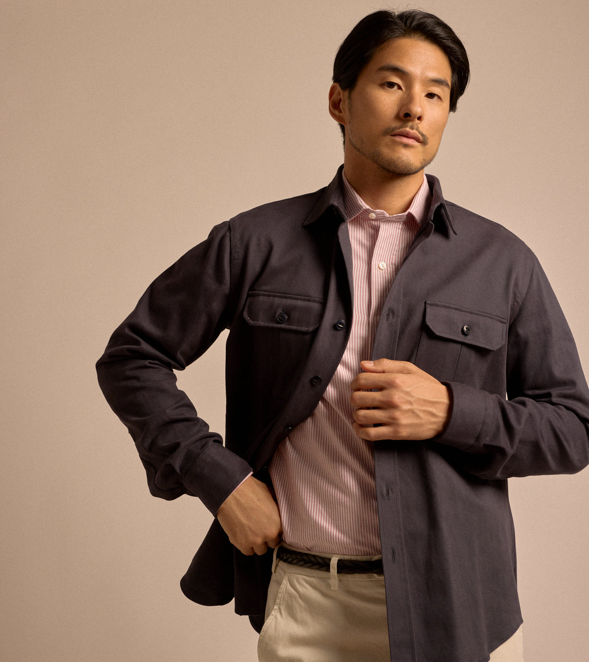 Model wearing Salvatore Piccolo Cotton Twill Military Shirt in navy. Styled here with Salvatore Piccolo shirt in a red and white stripe, Anderson's braided leather belt and Palmer trousers in sand.