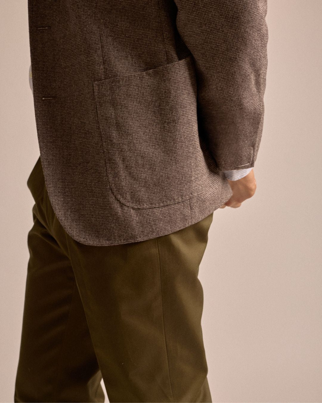Echizenya for Trunk heavy chino trousers in olive. A styled shot showing the model wearing the trousers in a side angle.