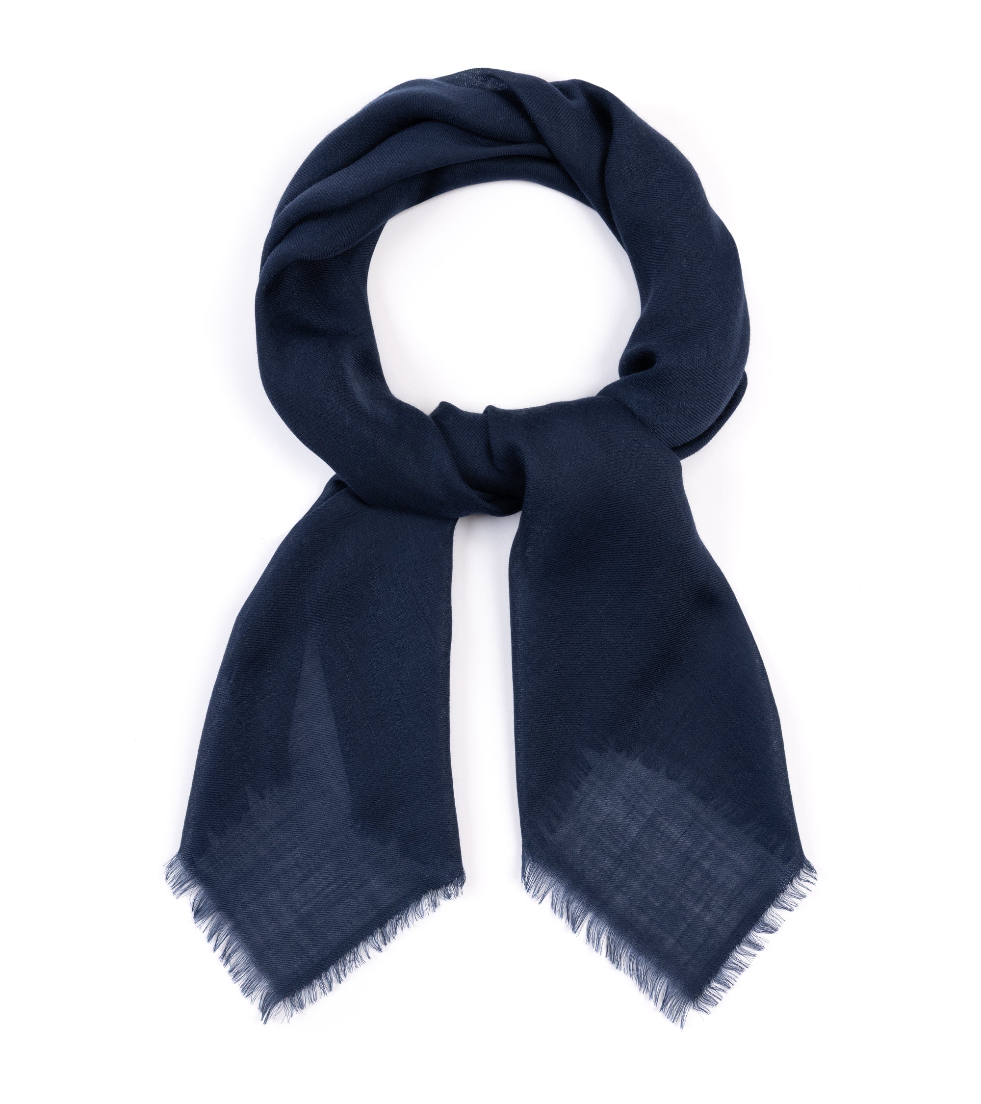 A dark navy blue scarf with fringed edges, neatly arranged in a loop on a solid white background.