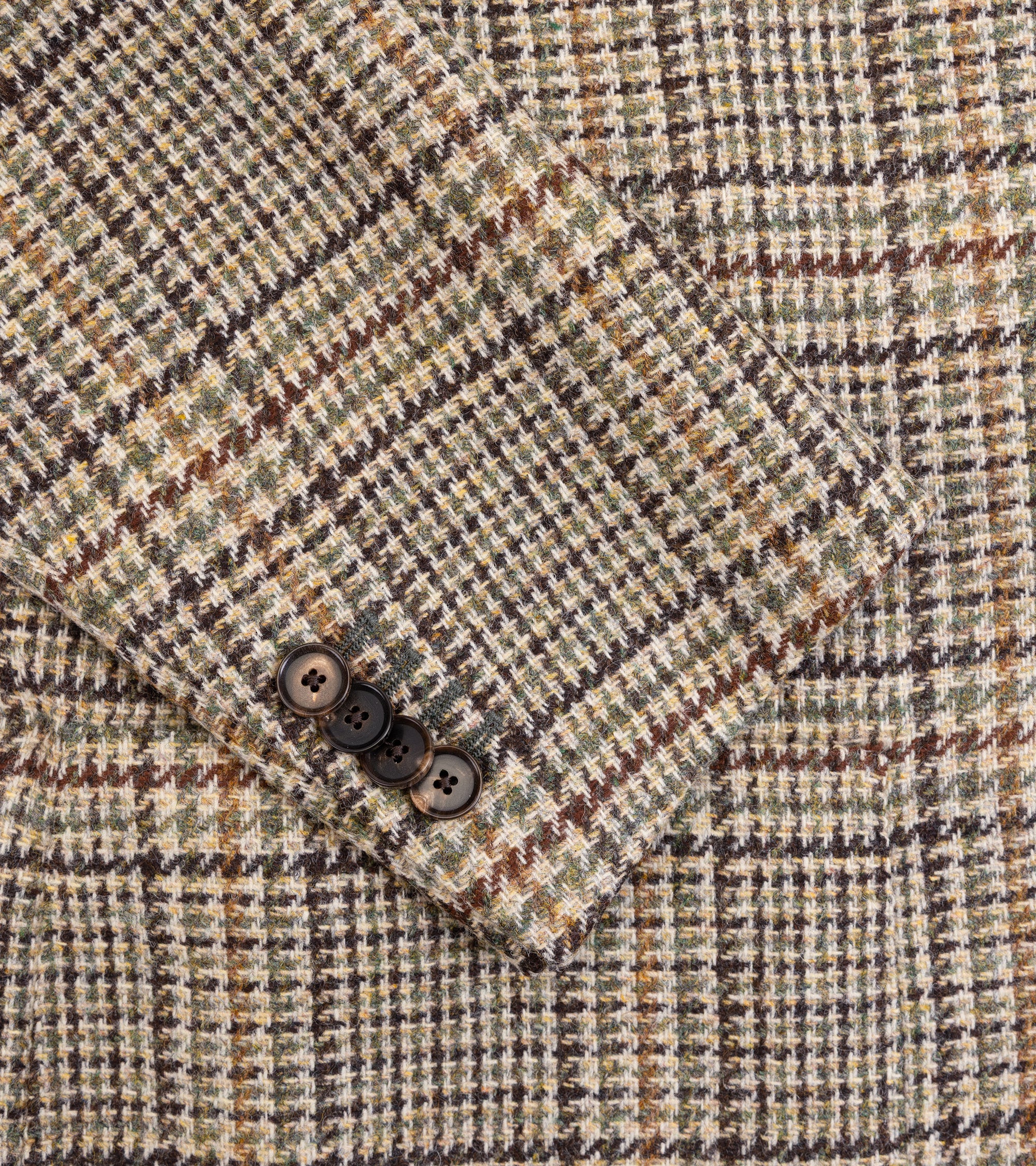 Caruso Aida Wool Large Glencheck Jacket in brown/green. Close-up detail of the Glencheck wool fabric and cuff with four buttons.