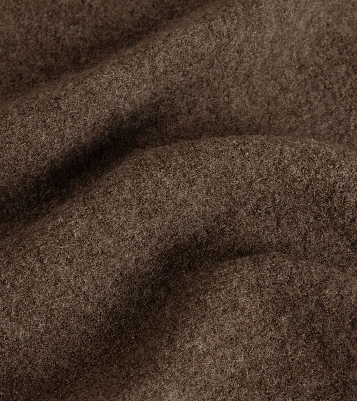 A close-up of fabric texture for the De Bonne Facture Boiled Wool Bookstore Jacket in Ash Brown.