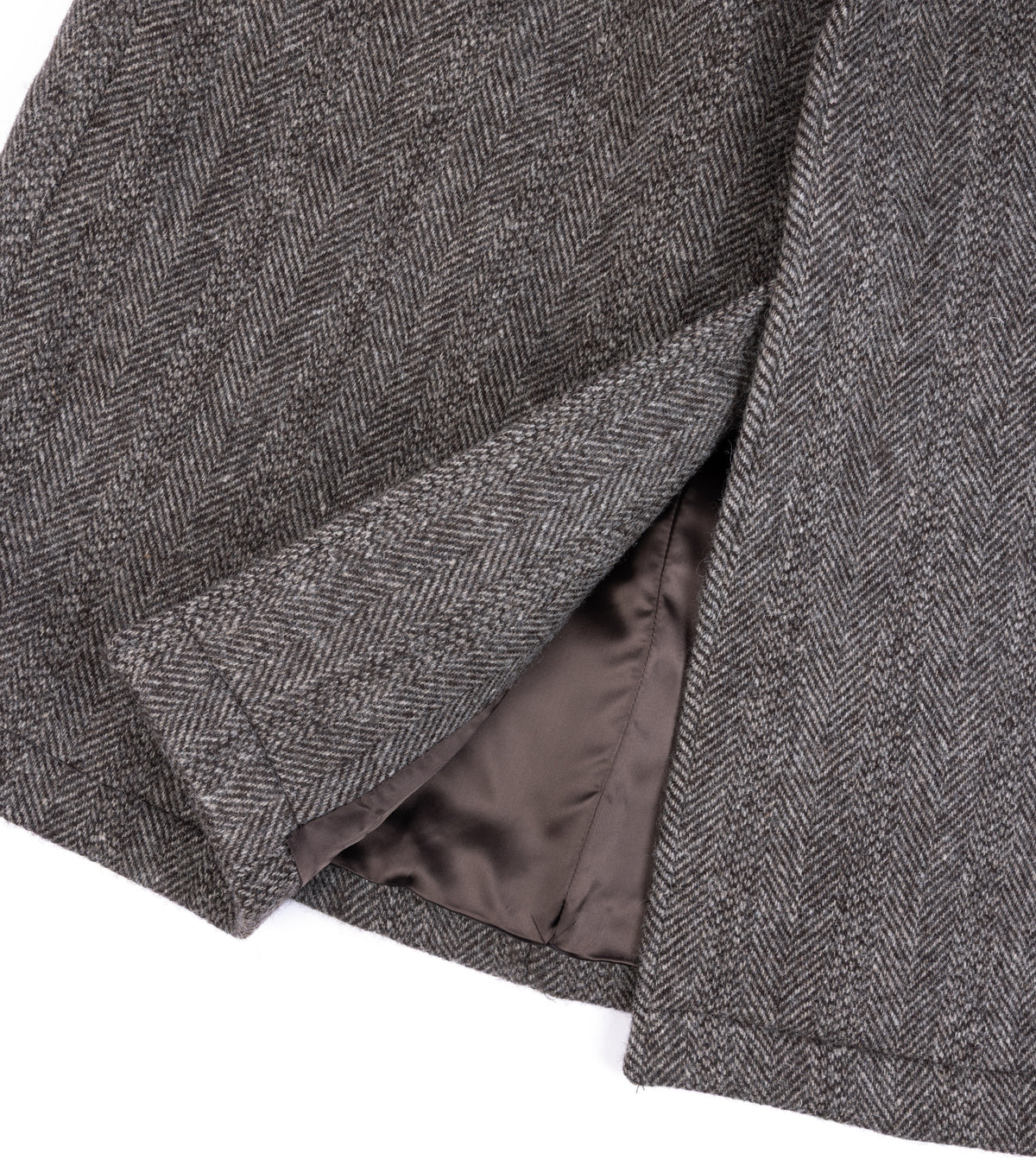 Close-up of De Bonne Facture Herringbone Wool Overcoat in Undyed Brown with a satin brown lining.