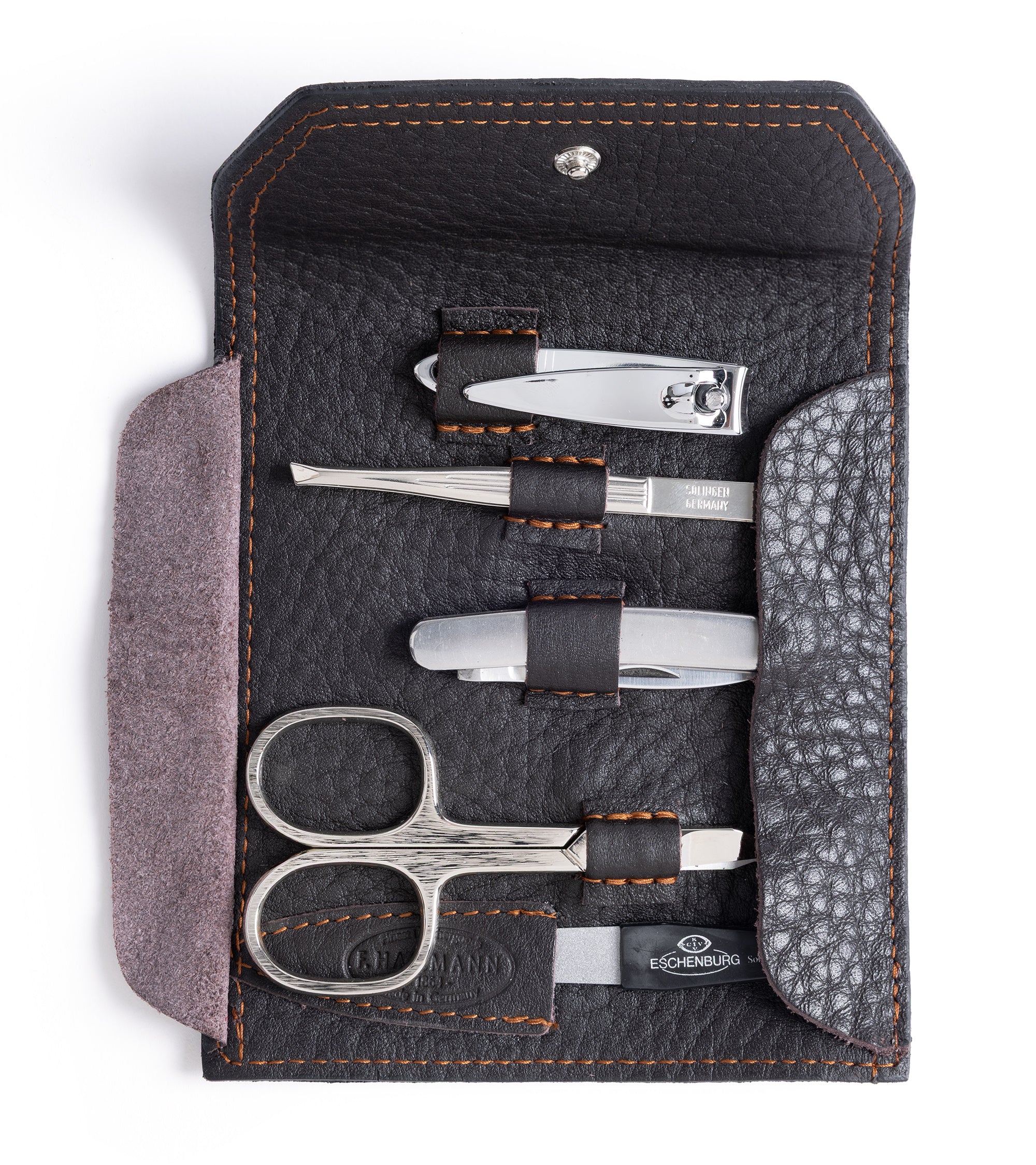 F. Hammann leather grooming set in dark brown, showing the inside detail and five-piece kit containing, nil clippers, tweezers. folding knife, nail scissors and nail file.
