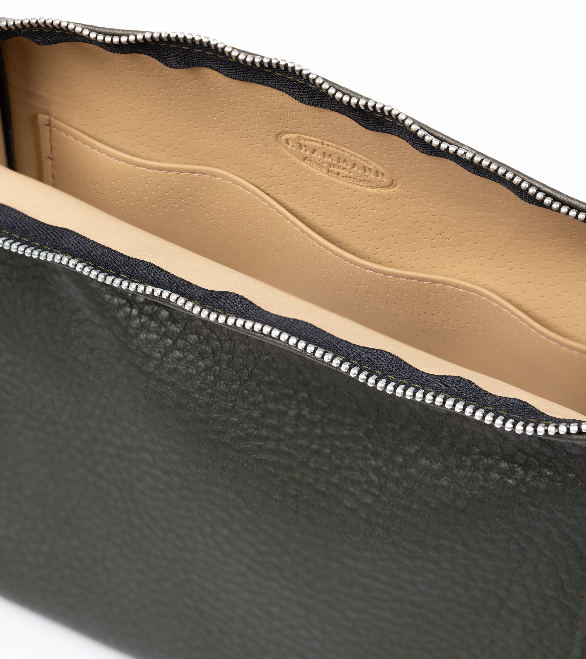 F. Hammann leather wash bag in olive, styled shot.