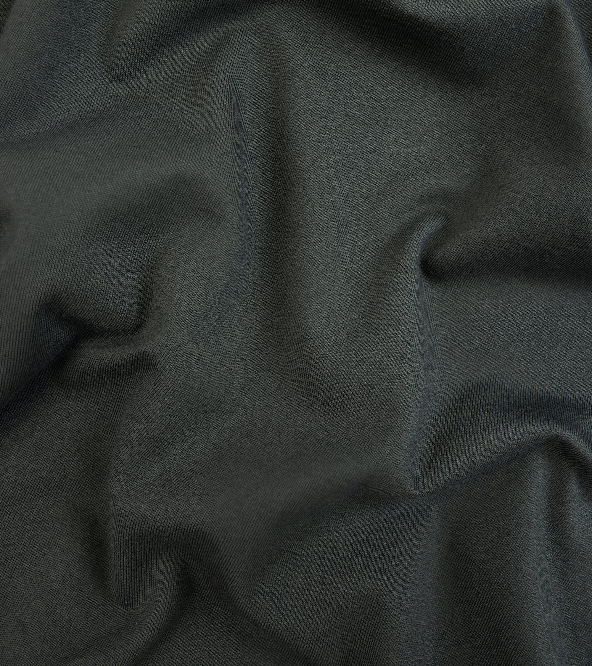Fedeli Zero Cotton Jersey Long Sleeve Polo Shirt in dark forest green. Close-up detail of the organic cotton fabric.