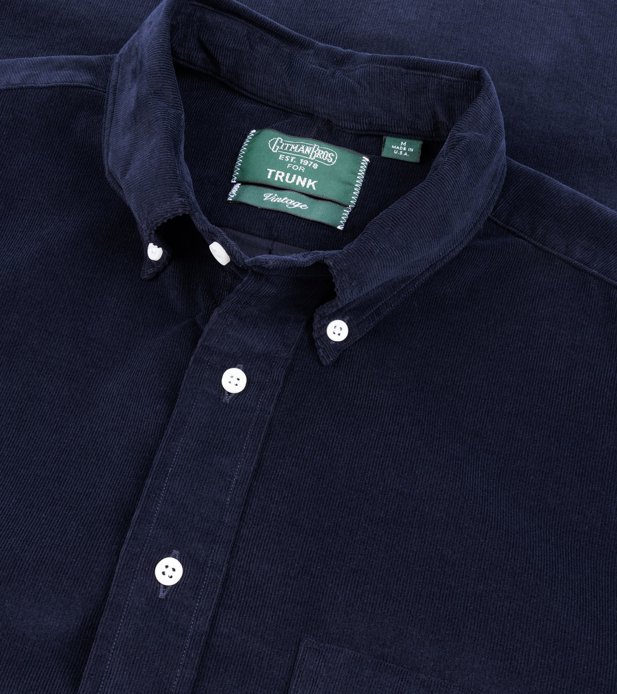 A close-up of the Gitman Vintage Fine Cord Button Down Shirt in Navy showing the collar, front buttons, and fabric texture.