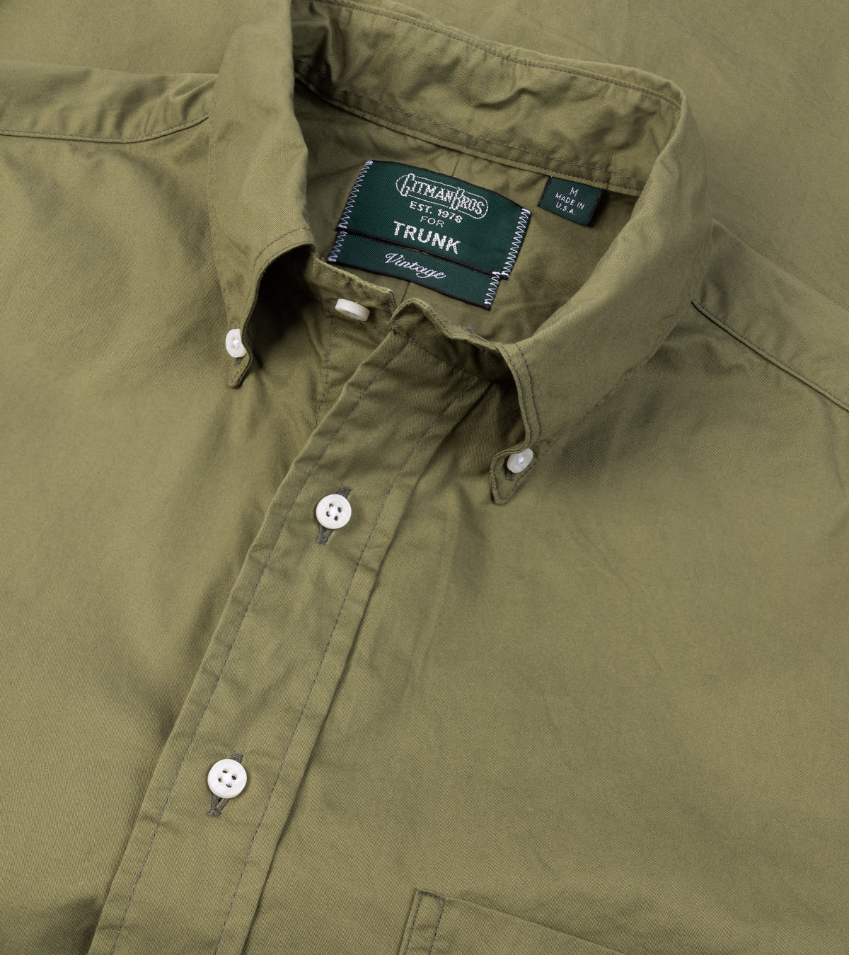 A close-up of the Gitman Vintage Japanese Cotton Twill Button Down Shirt in Olive showing the collar and mother of pearl buttons.