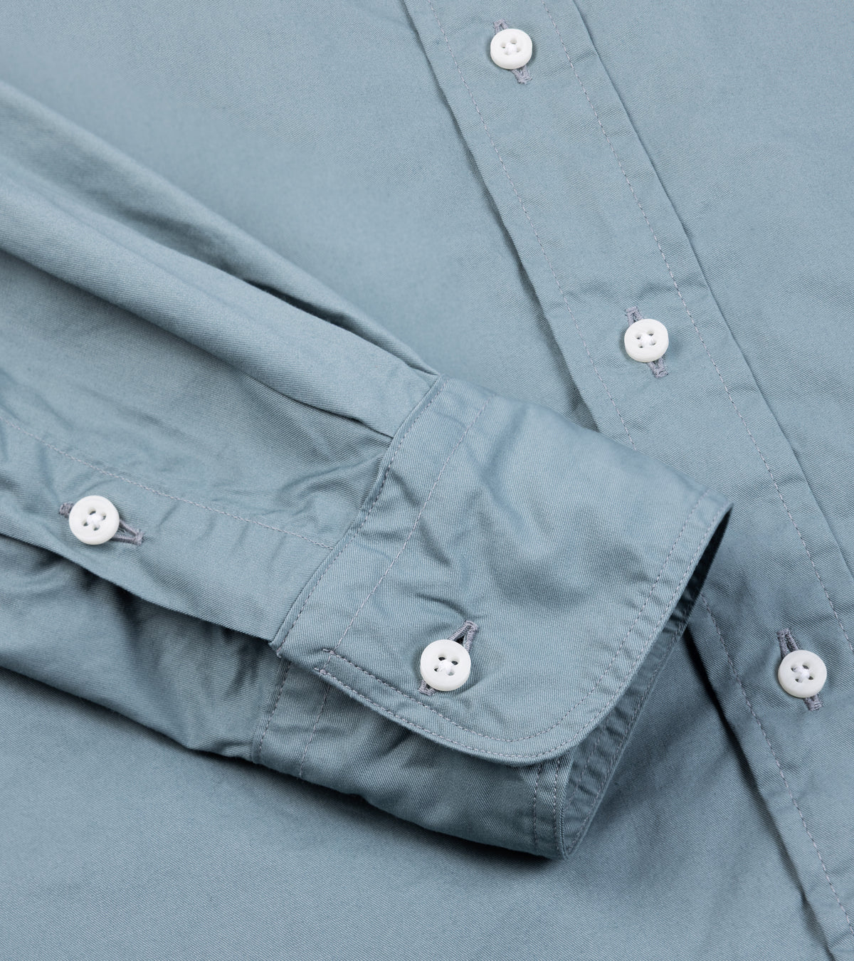 Close-up of the Gitman Vintage Japanese Cotton Twill Button Down Shirt in Slate Blue showing the buttoned cuff and fabric texture.