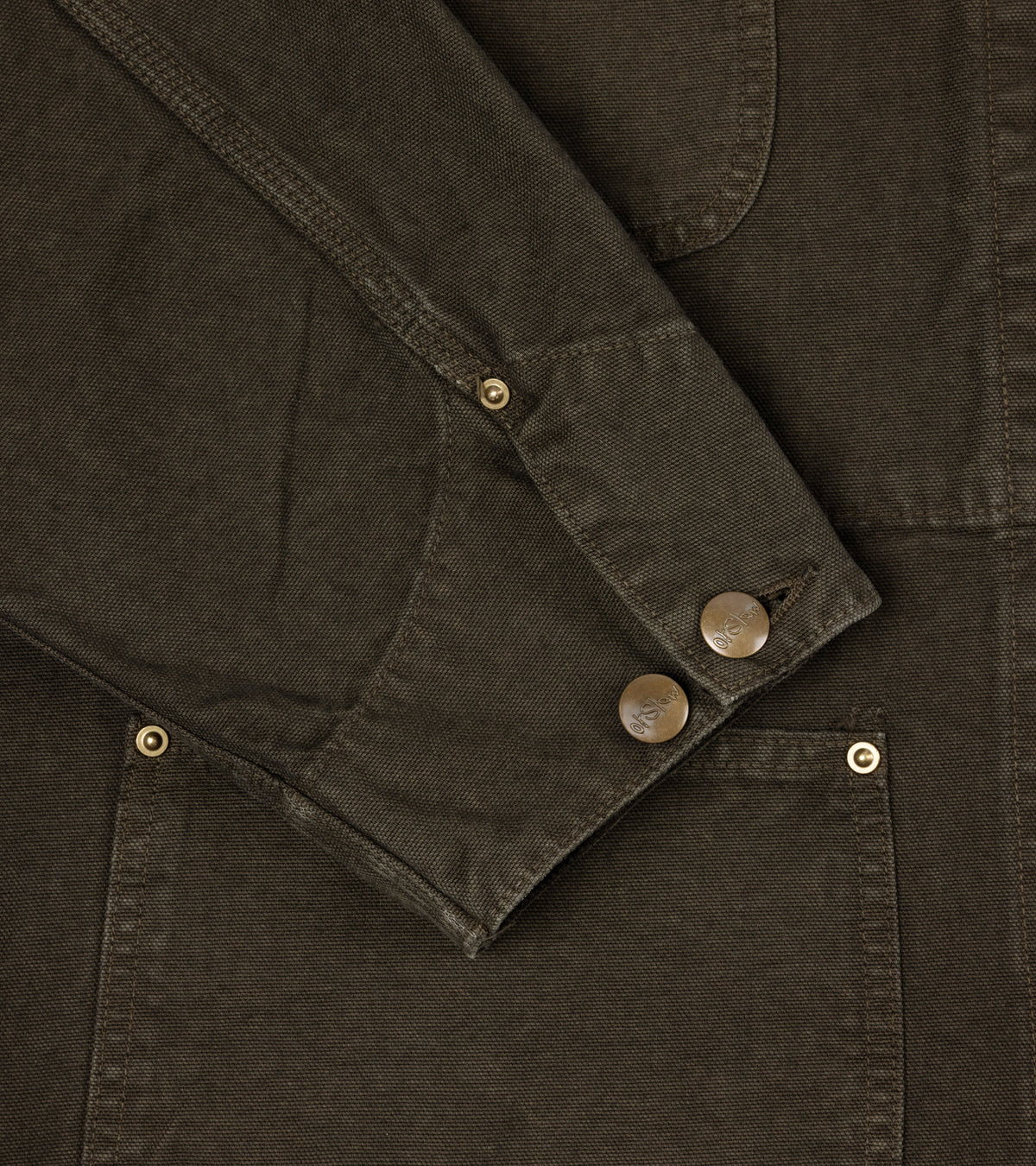 OrSlow Oxford Cotton Coverall Jacket. Close-up of the sleeve with a buttoned cuff and brass-toned metal rivets.