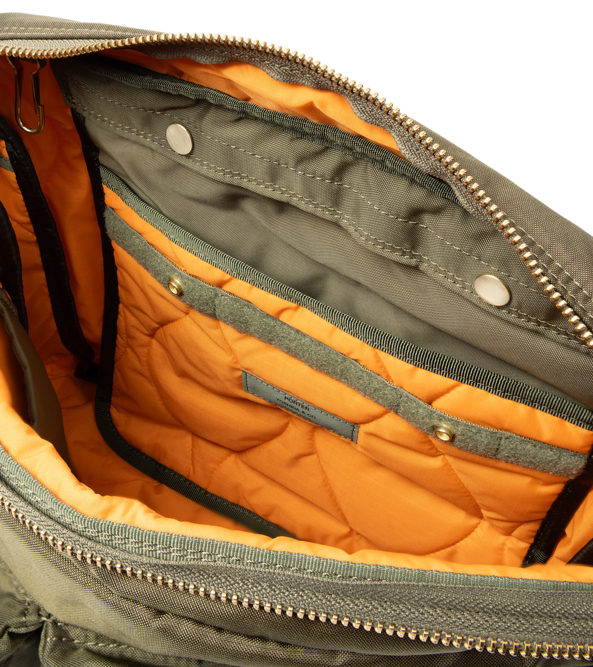 PORTER Force Shoulder Bag in Olive. Shot of inside the bag. Detail of the orange quilted lining and inside pocket.