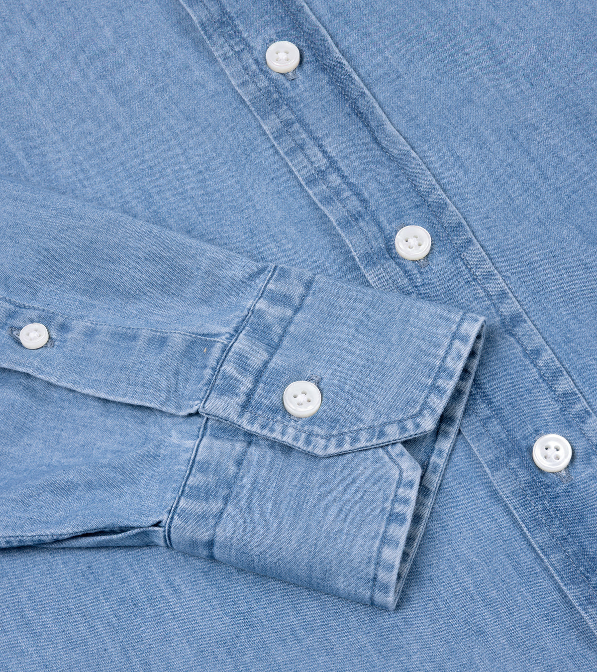 Salvatore Piccolo Cotton Chambray Shirt in Light Blue. Close-up detail of the buttoned cuff on the sleeve and front placket.