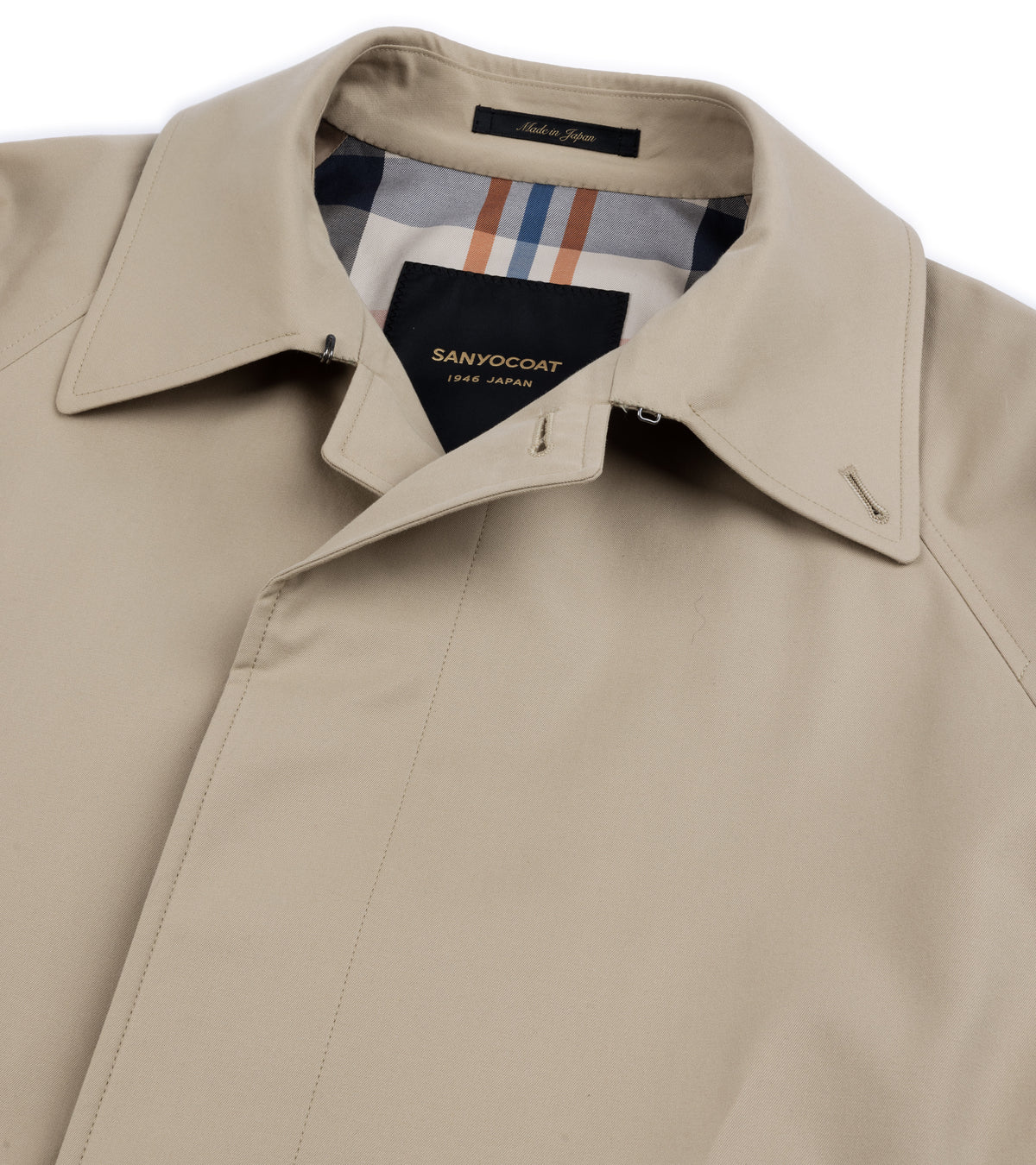 Close-up collar and lining detail of the Sanyo 100 Year Lightweight Gabardine Balmacaan Coat in Beige. Made in Japan label shown on the collar.