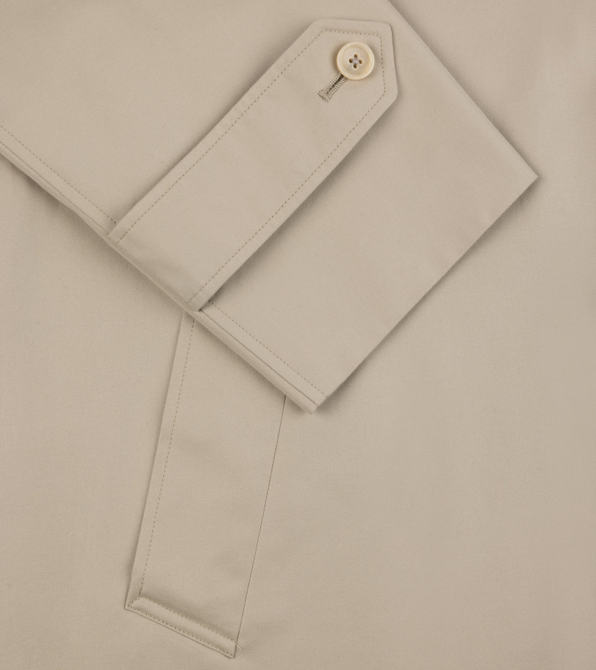 Close-up of the adjustable cuff on the sleeve and pocket detail of the Sanyo 100 Year Lightweight Gabardine Balmacaan Coat in Beige.