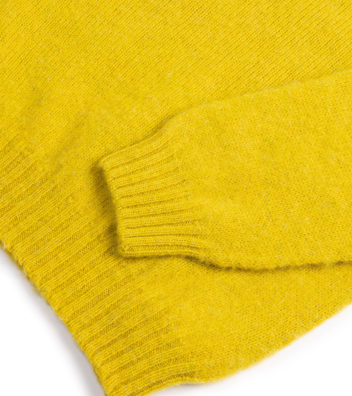 Close-up of the Trunk Goswell Brushed Lambswool Crew Neck Sweater in Citrus showing the ribbed cuff and hem.