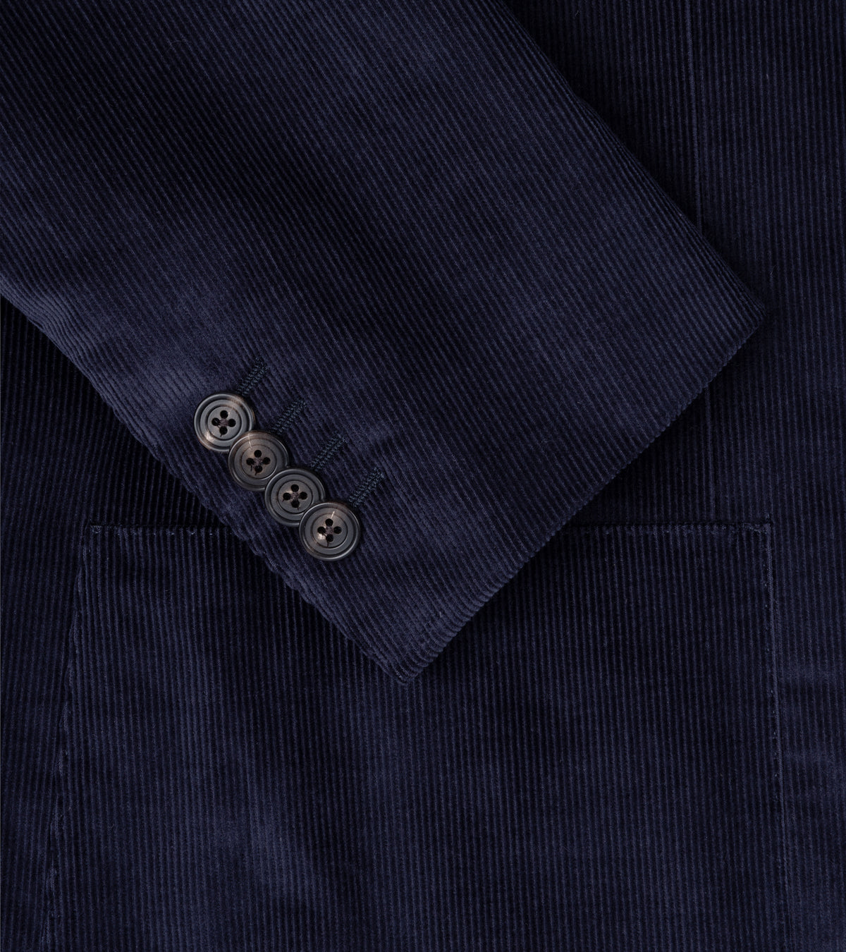 Trunk Hutton Cotton Corduroy Tailored Jacket in Navy. Close-up detail of the sleeve, pocket and corduroy fabric.