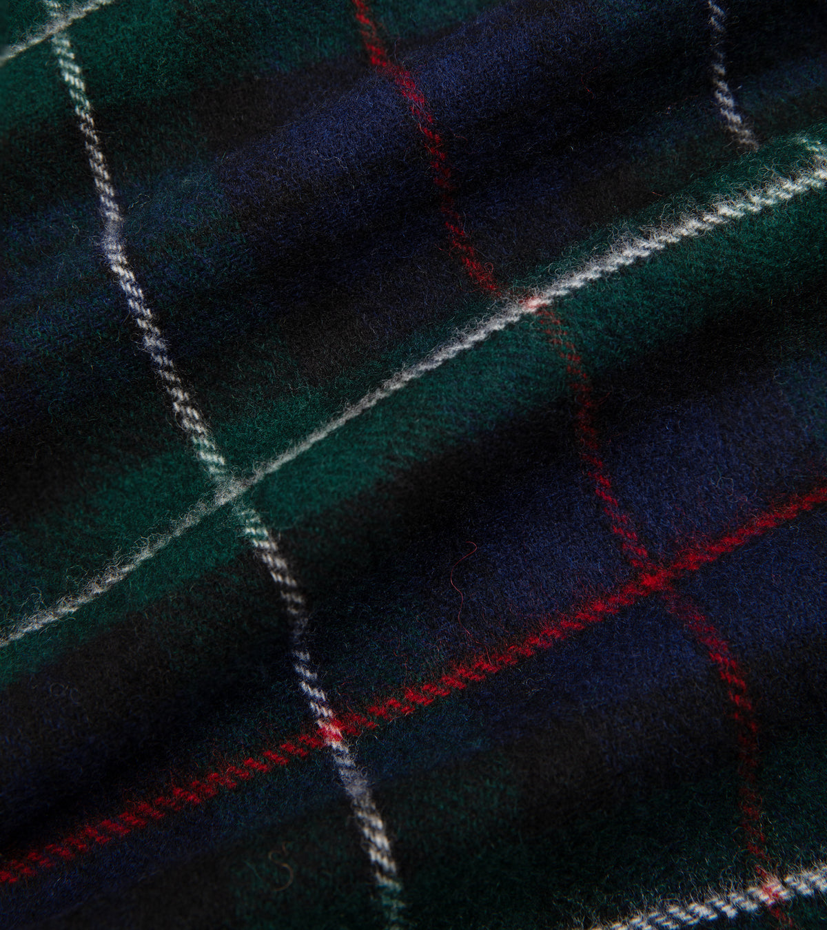A close-up of the Trunk Moon Merino Check Scarf in Navy showing the fabric texture and check design.