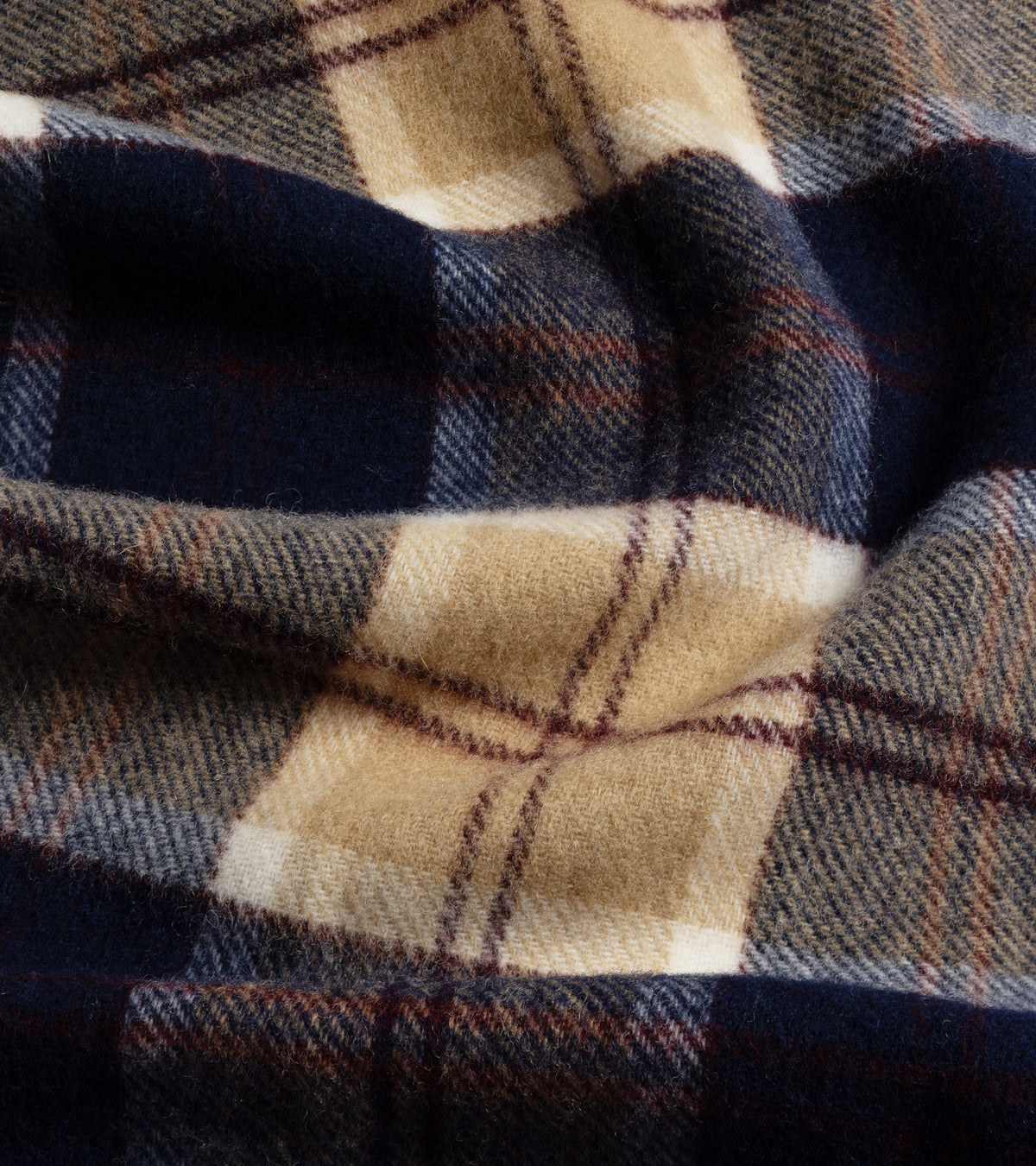 A close-up of the Trunk Moon Merino Check Scarf in Navy/Cream  showing the fabric texture and check design.