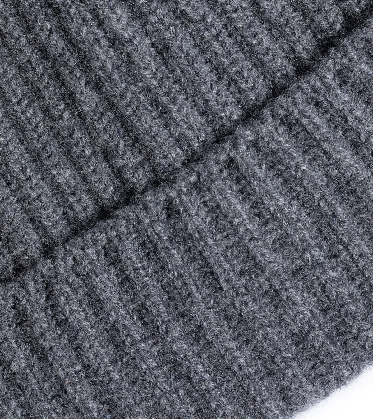 Close-up of the Trunk Seamless Ribbed Cashmere Beanie in Derby Grey showing the fabric texture and detailed weave.