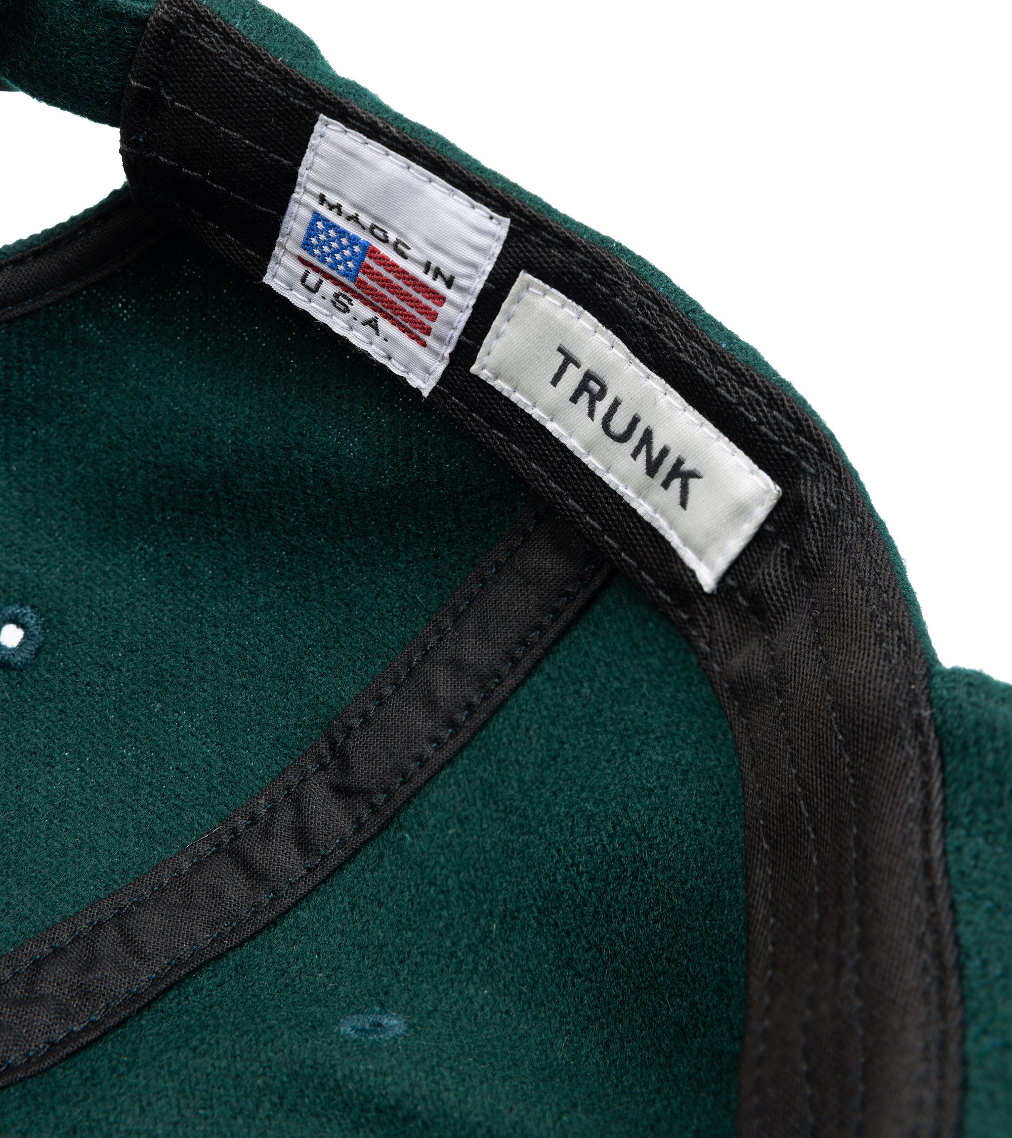 Trunk Wool Flannel Baseball cap in dark green. Inside detail of the cap showing Trunk and Made in U.S.A. label.