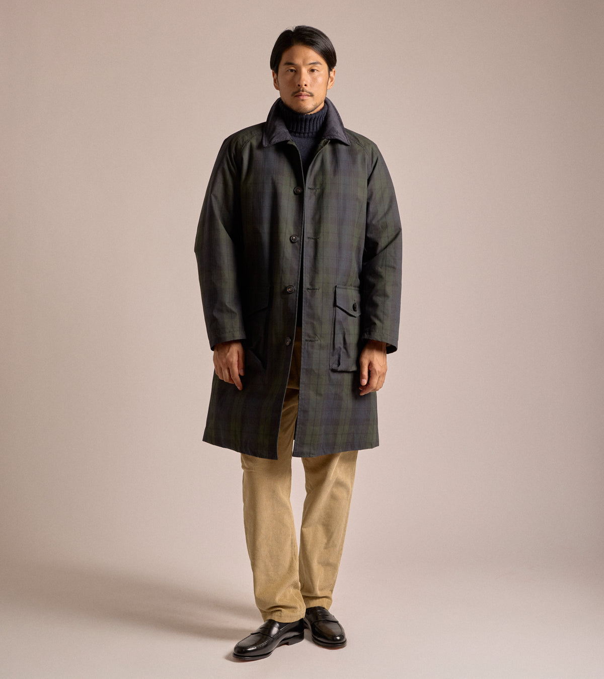 Model wearing the East Harbour Surplus Baxter Waxed Raglan Trench Coat in Blackwatch.